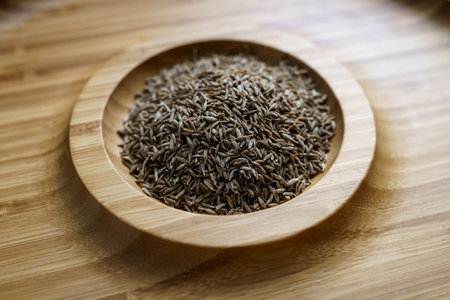 Cumin seeds in a wooden plateの写真素材