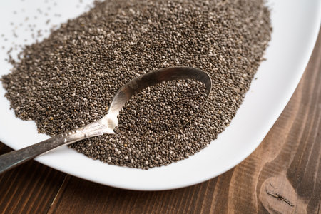 Raw black quinoa seeds on plate and spoonの写真素材