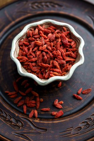 Dried goji berries in a clay bowl