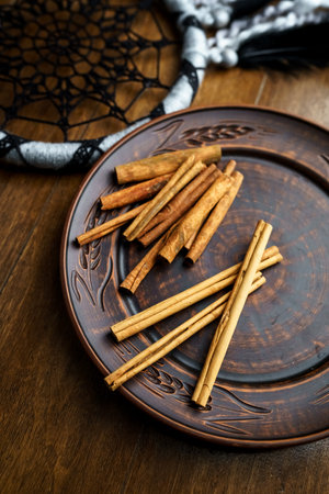 Cinnamon sticks on a clay plate vertically close upの写真素材