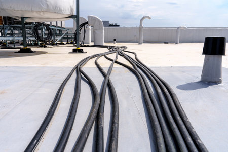 Laying cables and wires on the roof of an industrial buildingの写真素材