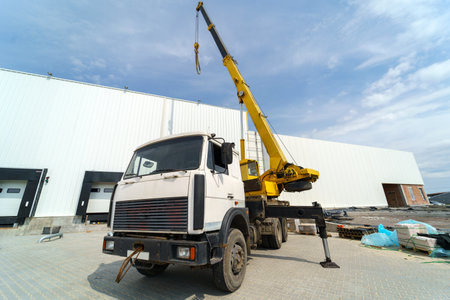 Crane truck against the background of a large warehouseの写真素材