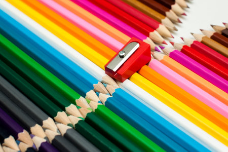 Stacked colored pencils and sharpener