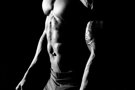 The abdominal muscles shows a young athleteの写真素材