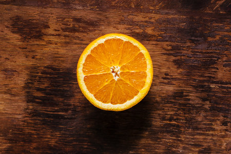Cut orange on vintage old wooden tableの写真素材