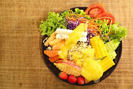 Vegetable and fruit salad on the plate for good health.の写真素材