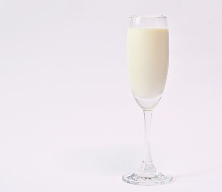 Glass of milk, white backgroundの写真素材