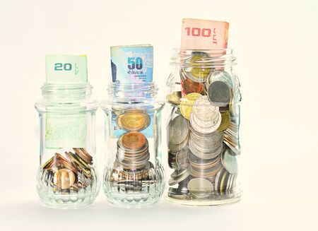 money / Coins in the glass bottle with the idea of saving money in the store.の写真素材