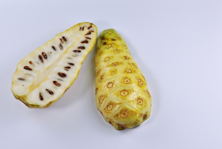 Noni cut a half on a white background.の写真素材