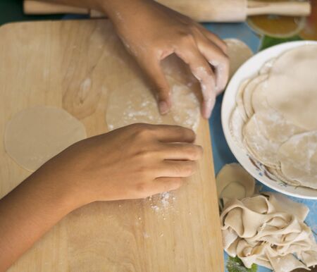 Making Gyoza plates is a plate with a dough kneader on a wooden cutting board. To be thinの写真素材