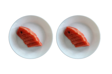 Watermelon in 2 white plates on a white background.の写真素材
