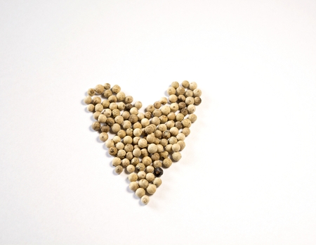 The dried pepper seeds are lined on a white background in the concept that the pepper nourishes the heart. And the meaning of love health.の写真素材