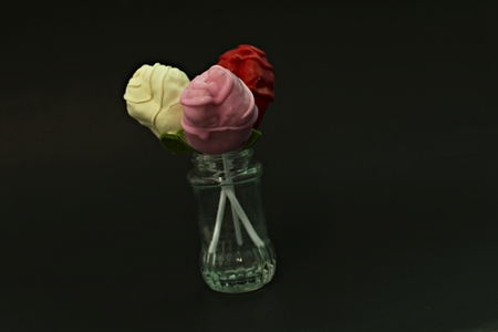 Chocolate Roses in Glass Bottles on a black backgroundの写真素材