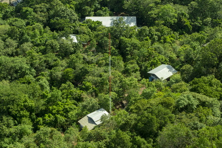 The house is surrounded by lush green forest in Thailand / Top View.の写真素材