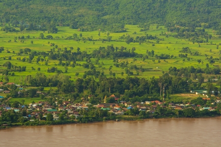 The village is located along the Mekong River in Laos, away from the village to fields and meadows. High angle view (top view)の写真素材