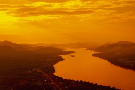 The scenery of mountains, rivers, red skies and orange in the evening, naturally occurring. Make this world beautiful.の写真素材