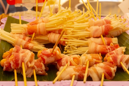 Bacon pork with enoki mushrooms prepared Thai style.Focus on the front
