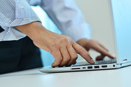 Office workers are keying information on computer screens.の写真素材