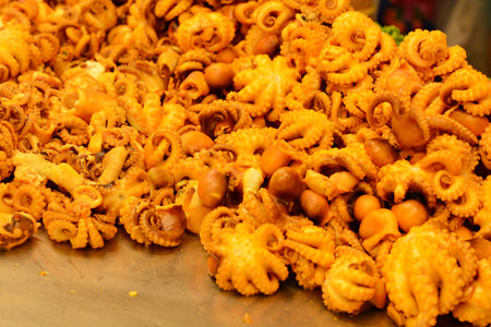 Small squid with tentacles cooked and ready to eat/close-up photographyの写真素材