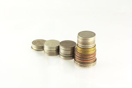 Savings, increasing columns of coins isolated on white 