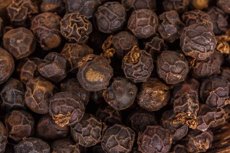 close-up of black pepper grains as backgroundの写真素材