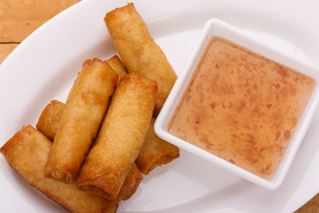crispy spring rolls on dish with plum sauce