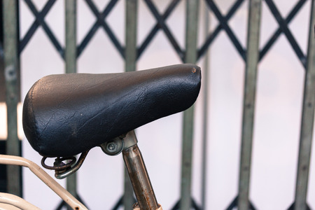 vintage leather bike saddle with metal springの写真素材