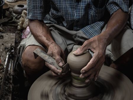 Master are molding clay to make earthenwareの写真素材