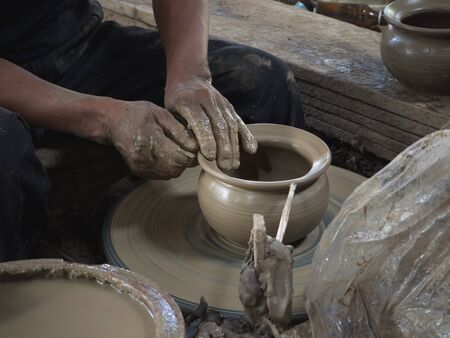 Master are molding clay to make earthenware
