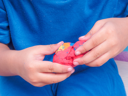 closeup of child play modeling clayの写真素材