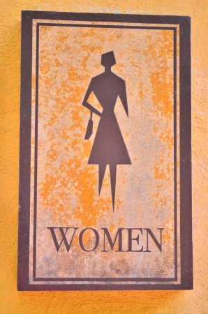 women toilet sign on yellow wallの写真素材