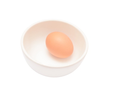 Eggs in a cup isolated on a white backgroundの写真素材
