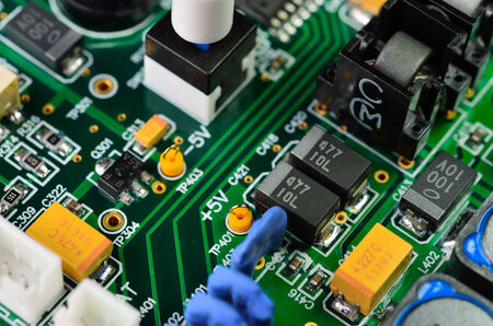 Detail of an electronic printed circuit board with many electrical components