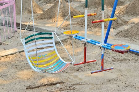 Empty swing on children playground in city.