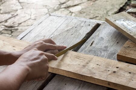 Sawing blades with bare hands by amateur carpenter.