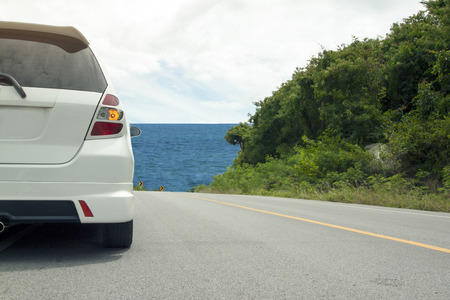 Car running on the road for travel trip have mountain beach and tree on mountainの写真素材