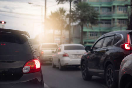 Traffic on the roads in the provinces in the evening. Abstract and blurred of rear side of black car with turn on brake light.の写真素材