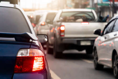 Rear side of blue car on the roads. Turn on brake light with other cars. Traffic congestion during...