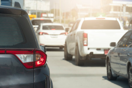 Rear side of family car gray color driving on the asphalt road. Drive in the business time or trip to travel. traffic jam on the road during rush hour. Environment in the city.の写真素材