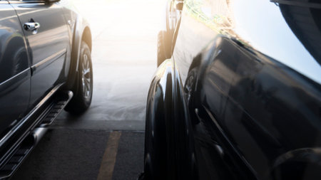 Abstract beside view of two car parking in parking area or prepare for race. on half of asphalt and concreate road with yellow split middle.の写真素材