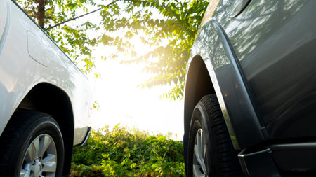 <p>End of the car gray color and white color. Parked under the shade of wood With a background with light</p>の写真素材
