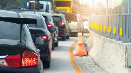 Abstract to blurred of cars on the cement road. Cars parked in a long queue during rush hour. Curved...