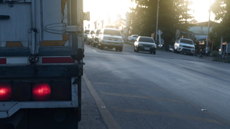Brake light of truck car on the road  with many cars blocking traffic signals across the street. Stop by traffic light condition.の写真素材