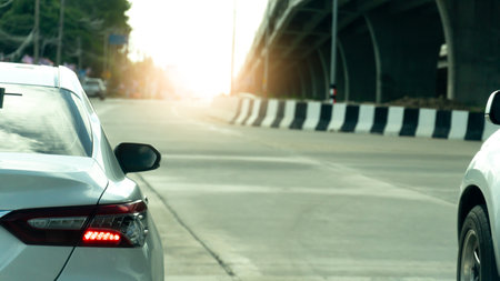 Rear side of white cars on concrete roads. During rush hours for travel or business work. Stop and...