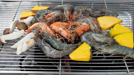 Grilled prawns, pumpkin and mushrooms on the griddle. Seafood food for relaxation.