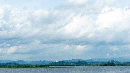 Horizontal view of river or reservoir of Prasae Wang Chan of Rayong. Background of mountain far the...