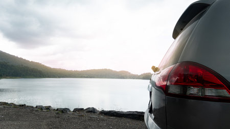 Taillights and rear of a grey car. Parking beside of the river or reservoir of Khuan Pluang Chanthaburi.の写真素材