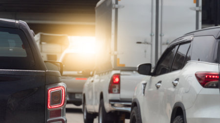 Congested traffic scene with multiple vehicles. including cars and a large truck. tightly packed on...