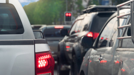 Rear side of pickup car with turn on brake light. Many cars are queuing up at a red traffic light.の写真素材