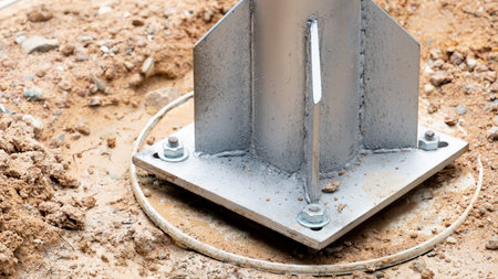 The base of the steel column is fixed with screws on the cement base. The cement is casted with plastic cans as the foundation of the pot.の写真素材